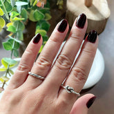 Zoomed-in photo of a model wearing a minimalist knot ring from Hill to Street